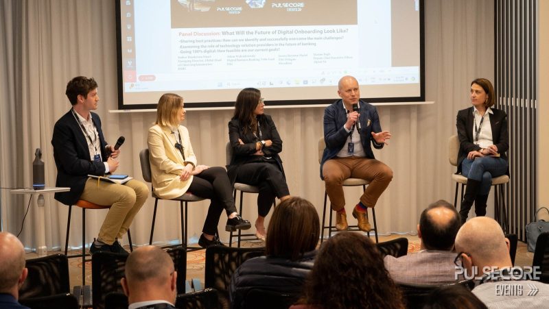 A five-person panel discussion on stage at a previous PulseCore event