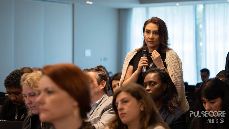 An audience member stands to ask a question at a previous PulseCore event