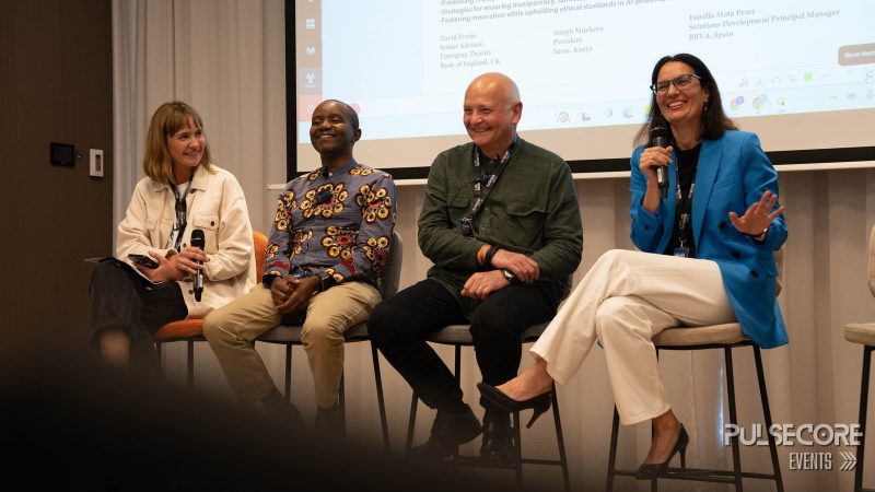 Four panellists seated on stage during a discussion at a previous PulseCore event