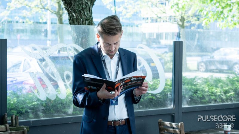A delegate reads the event programme by the window at a previous PulseCore event